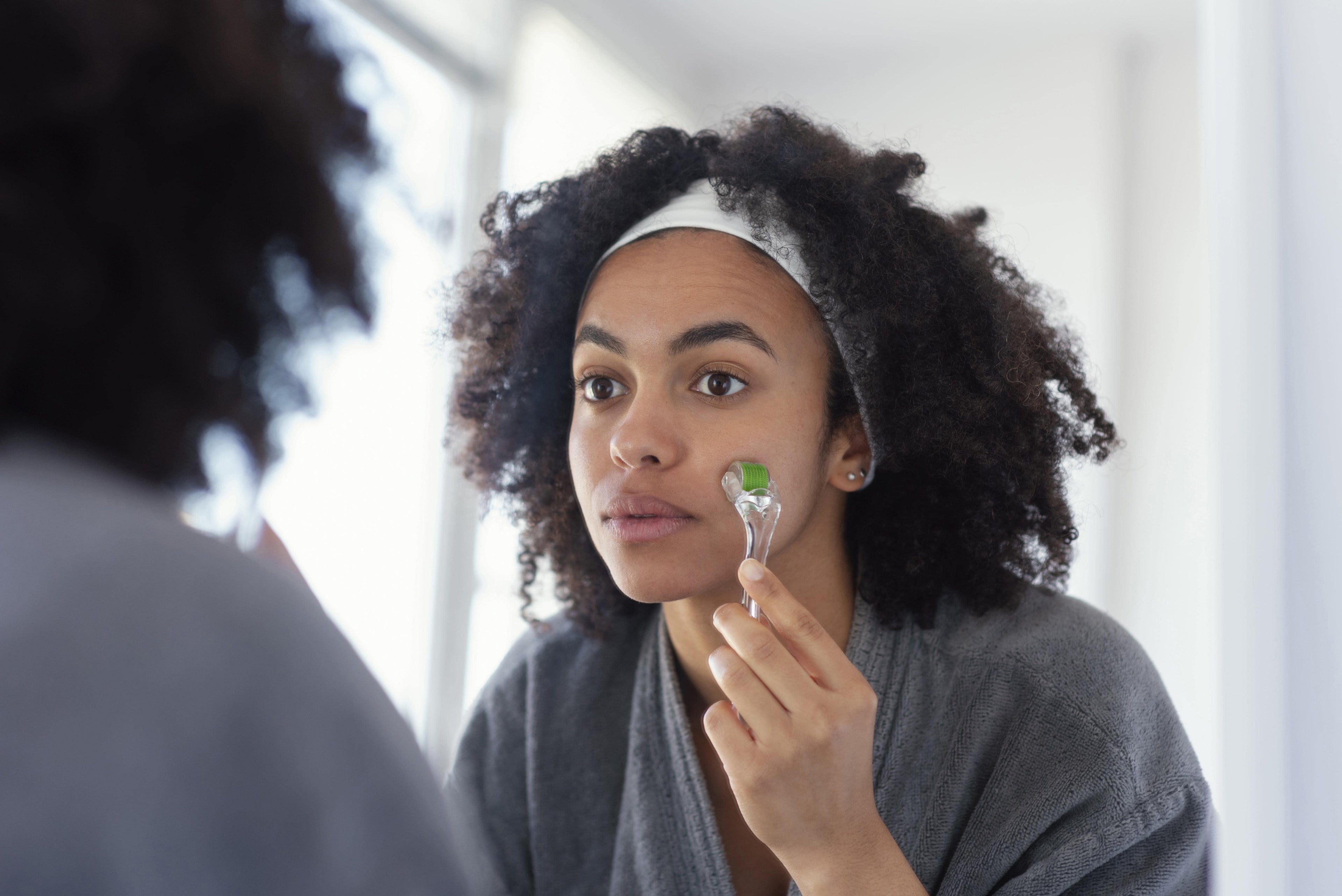 Close up woman massaging face for self-care corrector