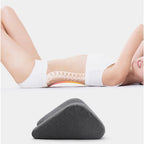 Person using a wedge pillow on a white background