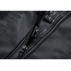 Close-up of a black jacket zipper and stitching details on a white background