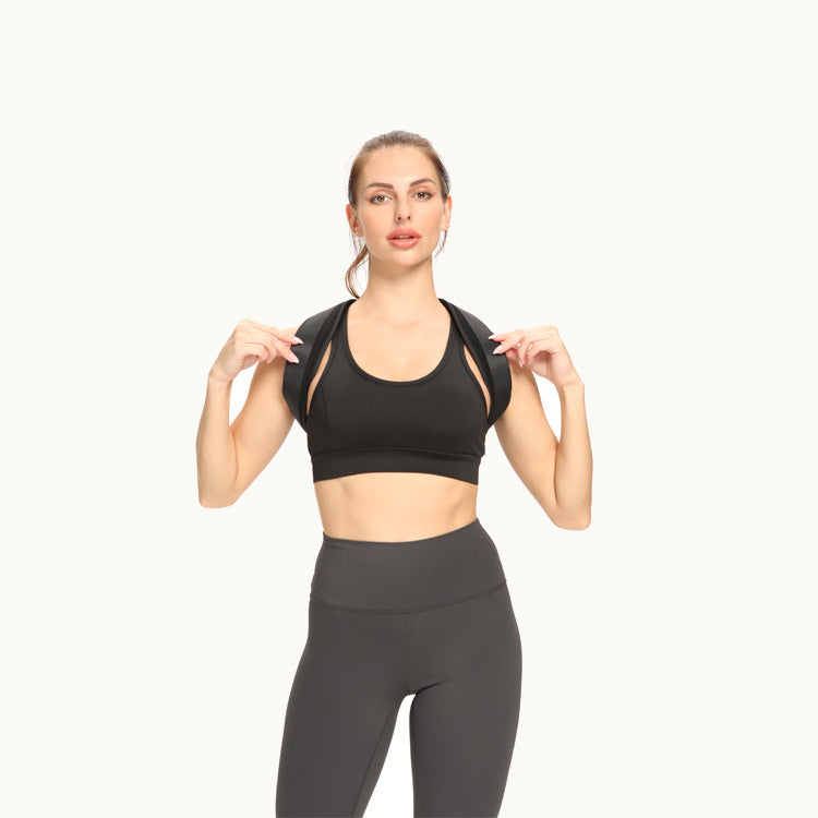 Woman wearing a black sports bra and gray leggings on a white background