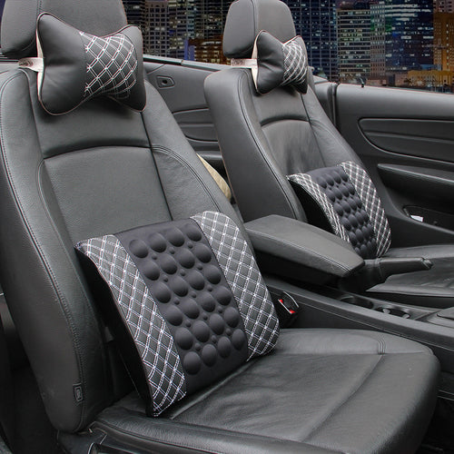 Car interior with massage seat cushion and headrest covers in a cityscape background