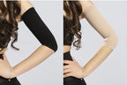 Comparison of black arm sleeve and bare arm on a plain background