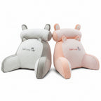 Two cartoon-shaped cushions, one white and one pink, with 'Good Lucky' text on a dark surface.