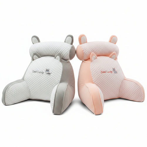 Two cartoon-shaped cushions, one white and one pink, with 'Good Lucky' text on a dark surface.