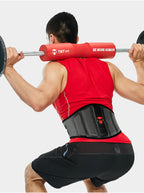 Person lifting weights with a TMT Fit back support belt on a white background