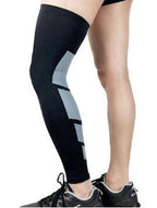 Black compression sleeve on a leg with a geometric design, worn over black sneakers on a white background.