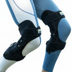 Person wearing protective knee and shin guards with a blurred natural background