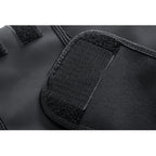 Close-up of a black tactical vest with velcro patches on a white background