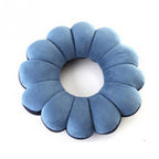 Blue flower-shaped cushion on a white background