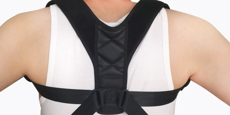 Person wearing a black posture corrector on a white background