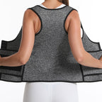 Person wearing a gray compression vest with black accents on a white background