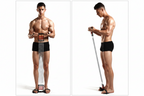 Man performing standing shoulder training with resistance bands on a white background