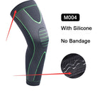 Gray knee brace with green accents and silicone texture, labeled 'M004' on a white background.
