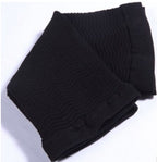 Folded black knitted scarf on a white background