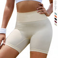 Beige high-waisted shorts worn by a person with a blurred green outdoor background