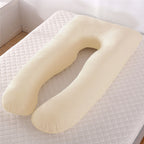 Beige U-shaped pillow on a textured surface