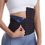 Person wearing a black waist trainer with blue accents on a white background