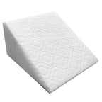 White wedge-shaped foam pillow on a white background