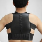 Black posture corrector worn by a person on a plain background