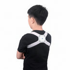 Person wearing a white back brace in a room with a light-colored wall and framed picture.